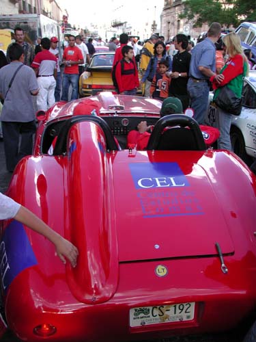 back of red car w crowd